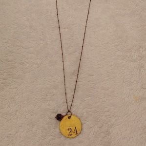 Pendant necklace gold and purple bead detail